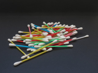 cotton swabs over black background
