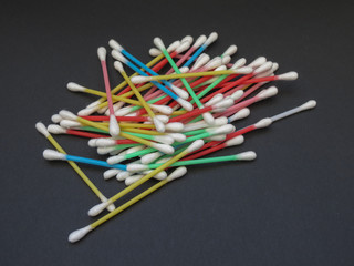 cotton swabs over black background