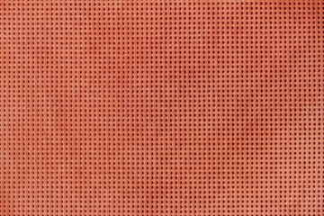 Obraz premium Texture of genuine geometric perforated leather close-up, painted orange brown color. For background, backdrop.