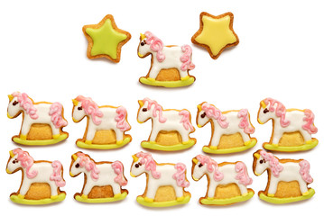 Unicorn shaped sugar cookies decorated with pastel royal icing on white background
