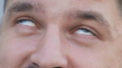 Man with a mustache and beard rolling blue eyes up getting high and lifting his head. Close-up, abuse addicted, high, junkie, having pleasure, tripping, crackhead, narcomaniac, pleased