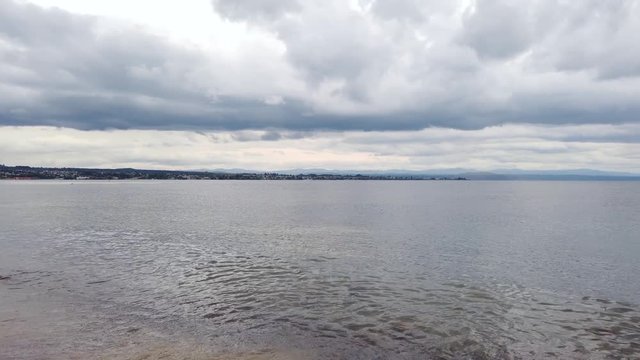 Pan right across Lake Taupo in New Zealand, calm water on New Zealands largest lake. 4k