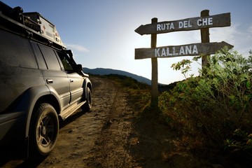 Road sign Ruta del Che, SUV on road, Santa Cruz, Bolivia, South America