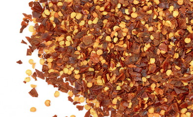 Cayenne pepper. Pile crushed red cayenne pepper, dried chili flakes and seeds isolated on white background
