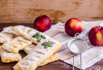 Fresh puff pastry pies stuffed with apples and cinnamon