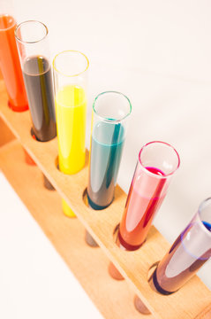 many test tubes filled with fluids of various colors