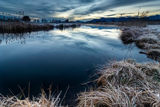 Water surface of the Ach with reflection and dramatic sky, Uffing, Staffelsee, Upper Bavaria, Germany, Europe