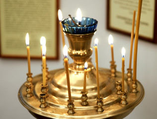 Church candlestick with burning candles.