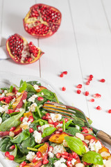 Salad. Spring vegetable salad. Fresh vegetable salad with grilled peach, pomegranate, spinach and fresh cheese
