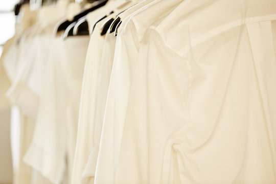 white women's blouses on hangers