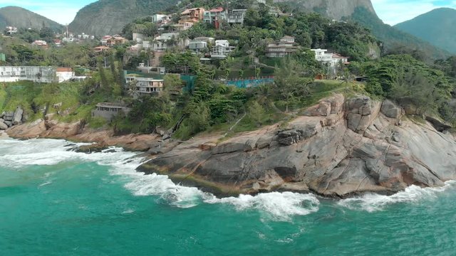 Closing in on the amazing beauty of the Joatinga beach with its cliff shoreline, small beach, the Gavea rock in the background and the green coloured ocean waves gentle rolling in