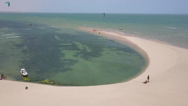Drone footage of two people on the beach watching kitesurfers in Dakhla, Morocco