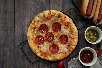 Party game day food Homemade Pizza hot dogs fries and dips ,top view