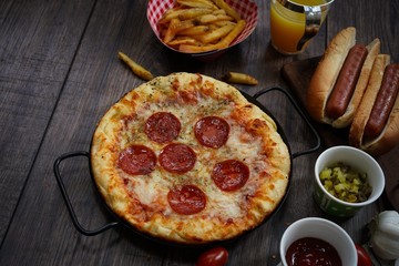 Party game day food Homemade Pizza hot dogs fries and dips ,top view