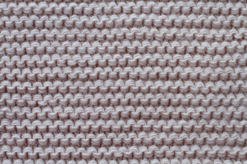 Light pink woolen knitted fabric texture. Macro.