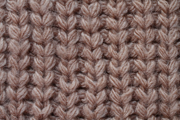 Light brown woolen knitted fabric texture. Macro.