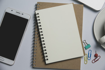 White office desk,  computer keyboard, mobile phone and other office supplies on table. Top view with copy space, flat lay.