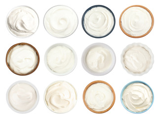 Set of delicious sour cream in bowls on white background, top view