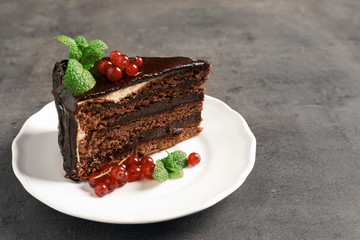 Plate with tasty homemade chocolate cake on grey table