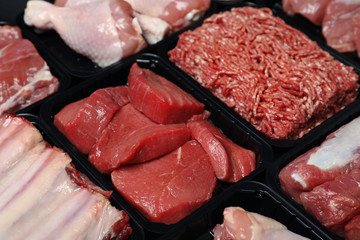 Containers with different raw meat, closeup view
