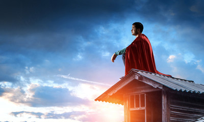 Super hero on roof. Mixed media