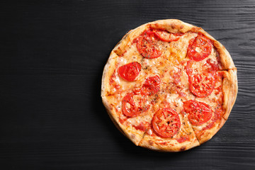 Hot cheese pizza Margherita on wooden table, top view. Space for text