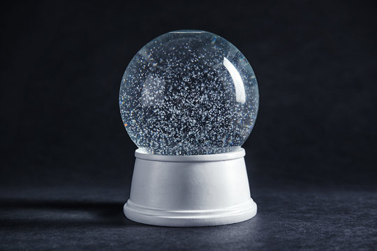 Magical empty snow globe on dark background