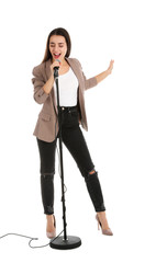 Fototapeta premium Young stylish woman singing in microphone on white background