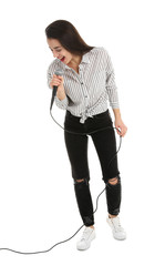 Young woman wearing casual clothes singing in microphone on white background