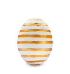 Traditional Easter egg decorated with golden paint on white background