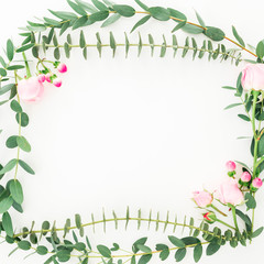 Obraz premium Floral frame of pink roses flowers and eucalyptus branches on white background. Flat lay, top view
