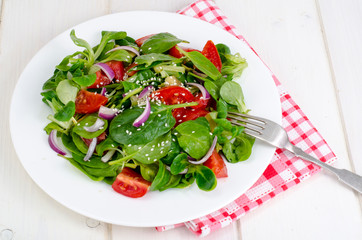 Concept of weight loss, healthy lifestyle. Light salad from fresh vegetables and herbs