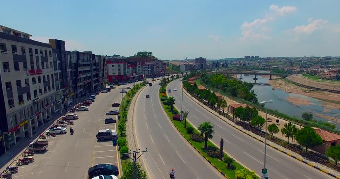Model road with buildings and river drone view, bridge on the river, cars running on the road, Chitwan, Nepal,