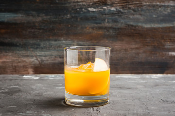 Old fashioned apple beverage on the rustic background. Selective focus.
