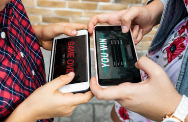 Little boy playing a mobile game against his sister