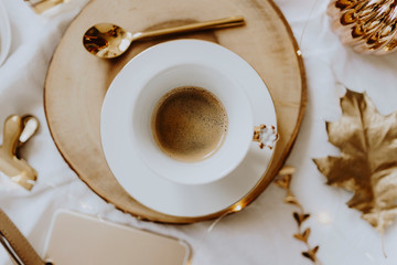 A cup of coffee served on a wooden tray