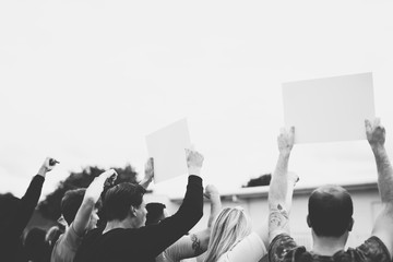 Rear view of activists showing papers while protesting