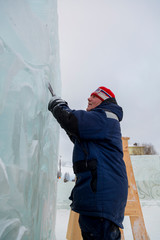 Portrait of a sculptor at work on a figure