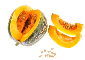 Whole round ripe pumpkin and sliced lobules on white background