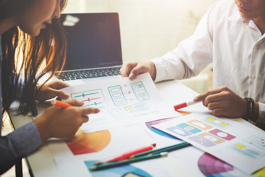 Designer working together to choose color swatch samples to editing artwork in the office.