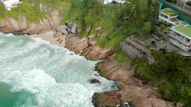 Beautiful picturesque Joatinga beach and cliff rock shoreline in Rio de Janeiro seen from above at sunrise