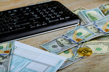 Pay tax concept USA Tax Form 1040 with US dollar bills and for April Calendar