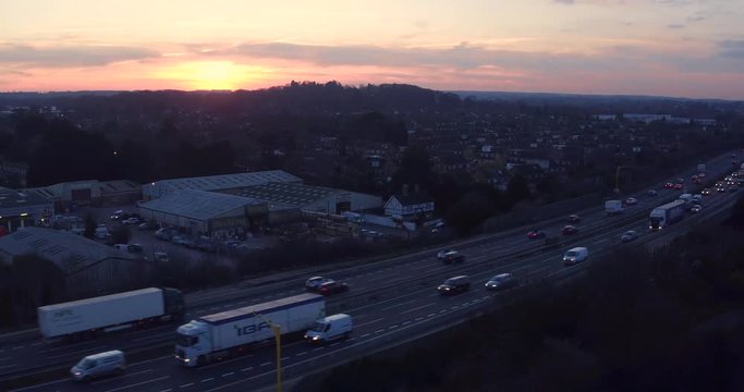 Aerial sunset reveal of M20 motorway traffic in Kent, UK
