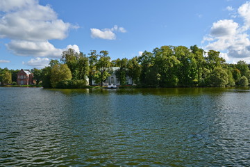 mansion on the island on the lake hidden among the trees