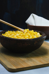 corn in a ceramic vessel and clay in the bottom of kitchen