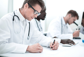 experienced doctor sitting at the laboratory table