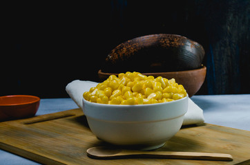 corn in a ceramic vessel and clay in the bottom of kitchen
