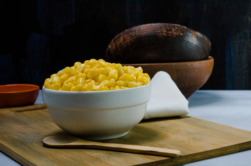 corn in a ceramic vessel and clay in the bottom of kitchen