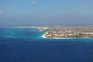 Naklejka na ściany i meble Aerial view of the Caribbean island of Aruba in approach to the Queen Beatrix International Airport (AUA) in Oranjestad