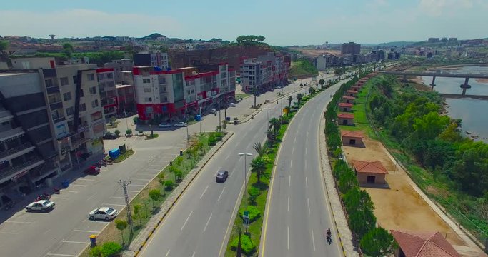 Highway follow shot from drone, buildings and river with the road, bridge on the river, Chitwan, Nepal